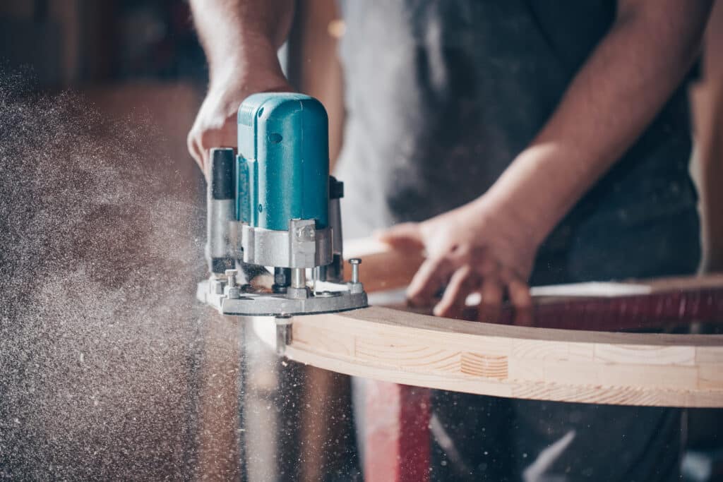 Joinery concept, woodworking and furniture making, professional carpenter cutting wood in carpentry shop