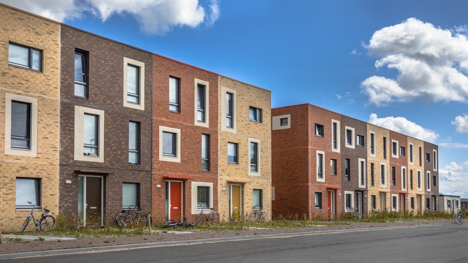 Modern Social housing under blue sky in terra colors containing modest family apartment houses